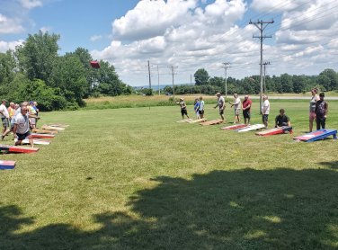 Camper's enjoying a game of corn hole at The Ridge Campground