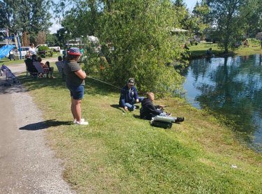 Kids fishing by the pond