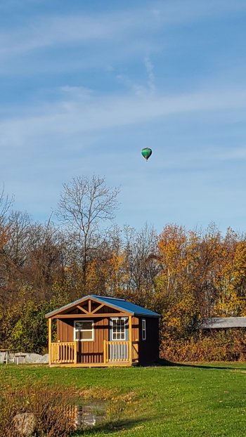 hot air baloon over blue cabin