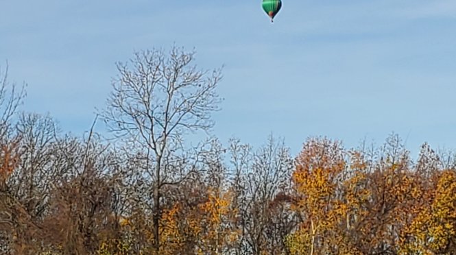 hot air baloon over blue cabin