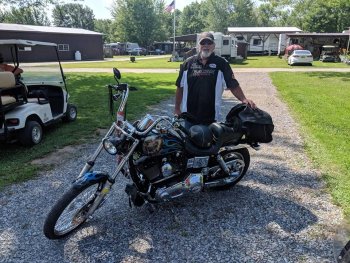 A camper and his motorcycle at The Ridge Campground