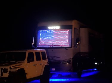 Camper with American Flag on the front of it