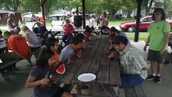 Camper's eating watermelon free-handed during the Hee Haw Olympics at The Ridge Campground