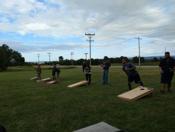 people plaaying corn hole